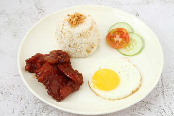 Freshly cooked Filipino food called Tocilog or cured pork, egg and fried rice