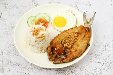 Freshly cooked Filipino food called Bangsilog or fried bangus or milkfish, egg and fried rice