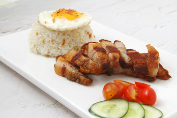 Freshly cooked Filipino food called Lechelog or crispy fried pork, egg and fried rice
