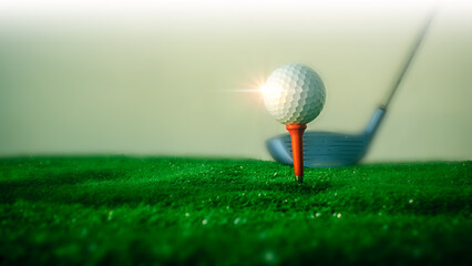 Close-up of a golf ball on the hitting platform Golf ball on red platform on green grass and golf club in the back ready to hit.Sports and health concept