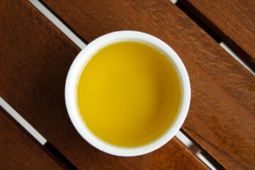 Bowl of natural olive oil  top view