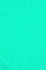 Closeup of saturated solid green mint urban wall concrete texture. Modern pattern for wallpaper...