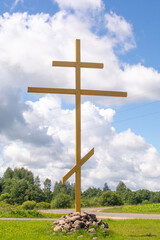 Large wooden cross on the sky background