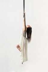 Woman hanging on aerial hoop