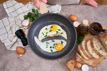 Close up view of the fried egg on a frying pan