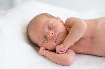 Newborn sleeping soundly and peacefully on white blanket. Birth baby - happiness for family. New worries and style life. Concept of child care, feeling safe, parent love.
