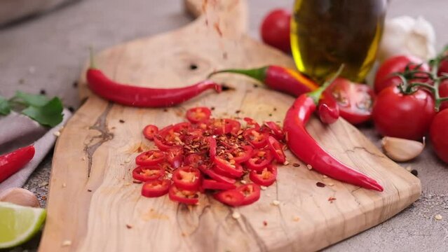 sliced chopped chili pepper on wooden cutting board at domestic kitchen