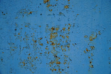Metal rusty surface with shabby background paint. Texture blue cracked paint on an iron sheet. Metal Corrosion