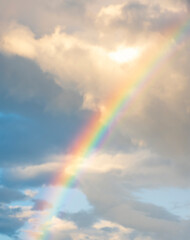 amazing bright rainbow in beautiful evening cloudy sky after rain and thunder, weather concept