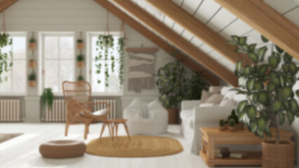 Blurred background, farmhouse mezzanine living room in boho style. Sofa and rattan armchair, oak wooden side table. Potted plants and decors. Bohemian interior design