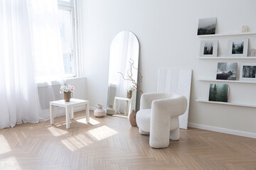 super white simple clean and stylish interior with modern furniture in nude color and contrasting black elements. luxury design of a large bright room living room