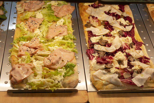 Italian Flatbreads Stuffed with Salad, Cheese, Mushrooms, and Various Sliced Meats
