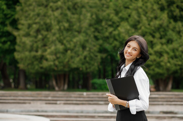 Obraz premium European businesswoman use mobile phone outdoors. Beautiful focused young girl wear formal suit. Modern woman lifestyle.