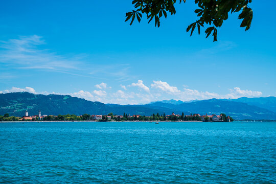 Germany, Lindau city island next to pfaender mountain at lake bodensee waterside view in summer with boats panorama