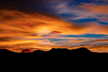 Sunset over the mountains. A colorful scene of sunset over a set of hill range.