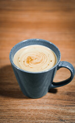 Cappuccino cup on a wooden table