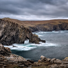 Fototapeta na wymiar Natural sea Arch near Strathy Point in Sutherland on the north coast of Scotland
