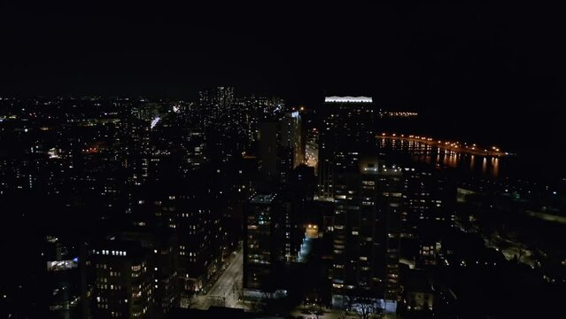 Drone view of cars running in busy streets of Chicago at night