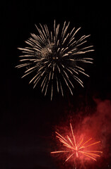 Silver firework with smoke over the black sky background. Low key exposure. Selective focus.