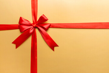 Top view of Red ribbon rolled and red bow isolated on colored background. Flat lay with copy space