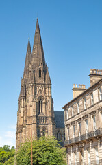 Obraz premium Historical and ancient city centre church or cathedral spire on a bright and sunny day