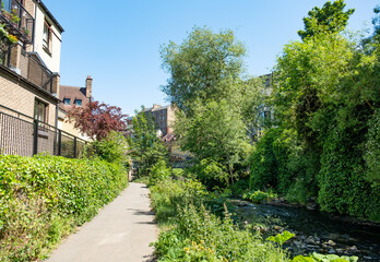 Fototapeta na wymiar Footpath along the Water of Leith towards the district of Dean in the city of Edinburgh on a bright and sunny day