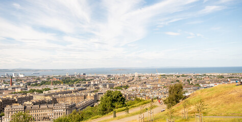 Edinburgh, Scotland, UK – June 20 2022. A view over the Edinburgh skyline towards the Firth of the Forth captured from Calton Hill