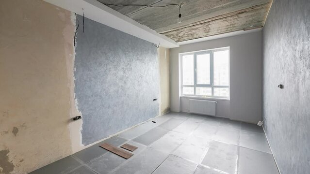 Comparison of old room with building materials and new renovated place with plastic window, parquet floor and gray walls. Video of modern apartment before and after renovation.