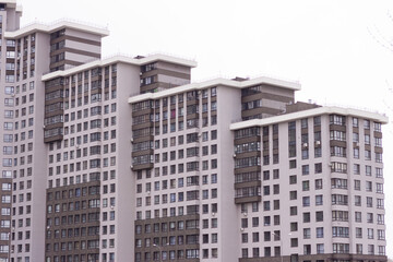 A block of residential blue and teal buildings from high to short one