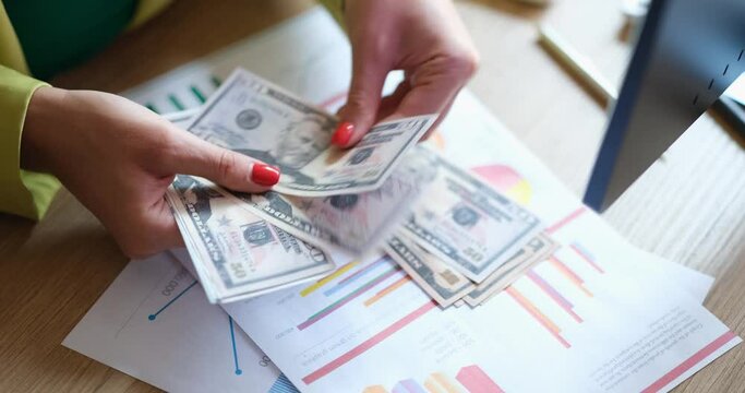 Women's hands in the office count dollars