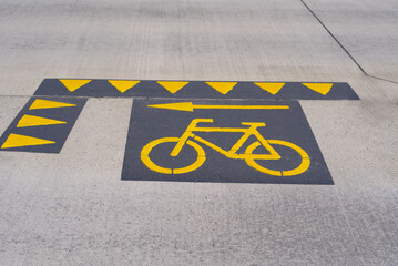 Bicycle icon with give way signs and arrow painted on road at City of Altdorf, Canton Uri, on a sunny summer day. Photo taken June 25th, 2022, Altdorf, Switzerland.