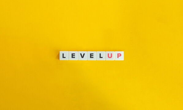 Level Up Banner and Phrasal Verb. Letter Tiles on Yellow Background. Minimal Aesthetics.