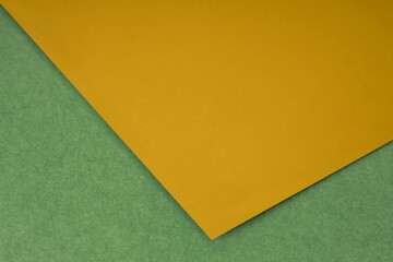 Plain Yellow paper sheet lying on yellow green textured Background like an open book from top angle	