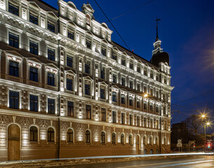 Fototapeta na wymiar Night cityscape of Riga. Lights on long exposure. Illuminated building