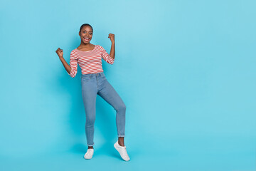 Fototapeta na wymiar Full body portrait of excited overjoyed person raise fists triumph luck empty space isolated on blue color background