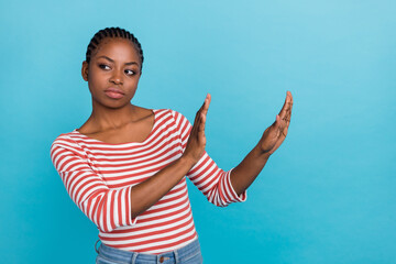 Photo of calm serious lady hands palms demonstrate stop gesture empty space isolated on blue color...