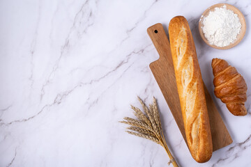 Baguette, croissant and flour , top view, flat lay. Light background, free copy space