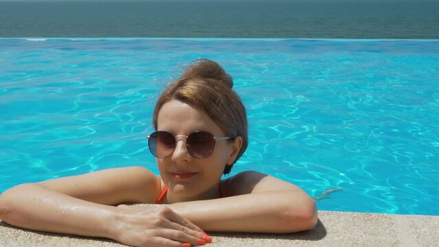 Portrait of Girl Resting Relaxing in Infinity Pool with Amazing Sea View. Vacation in Resort Hotel, Beach Villa.