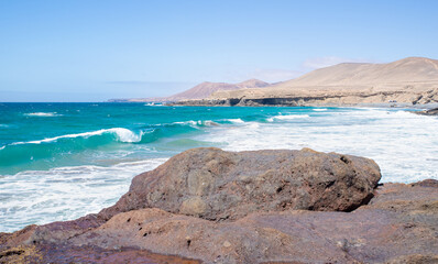 Fototapeta na wymiar Scenic View of Sealandscape with a Wave Coming Up to the Coast in Fuerteventura,Canary Island