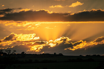 Fototapeta premium Skyscape cloudscape colorful dark orange blue sky clouds at evening sunset