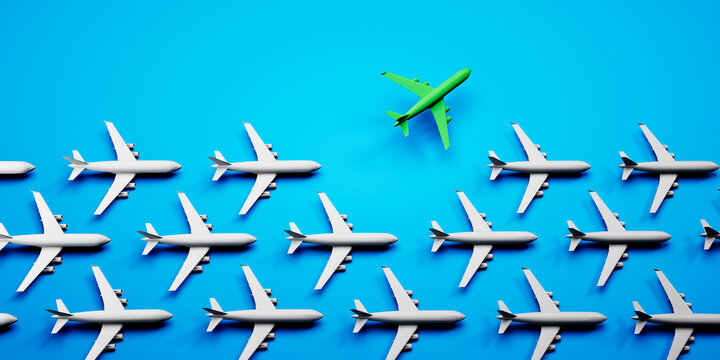 Group of white airplanes with green leader on blue background - green energy travel concept