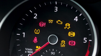 Many different car dashboard lights with warning lamps illuminated. Light symbol that pops up on dashboard when something goes wrong with the engine - Powered by Adobe