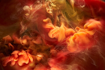 Liquid fluid art abstract background. Red, yellow dancing acrylic paints underwater, space smoke...