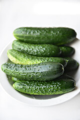 Green juicy cucumbers on a white background.