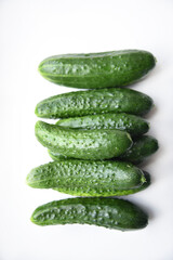 Green juicy cucumbers on a white background.