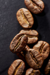 Fototapeta premium Roasted coffee beans isolated close up on black background, clipping path