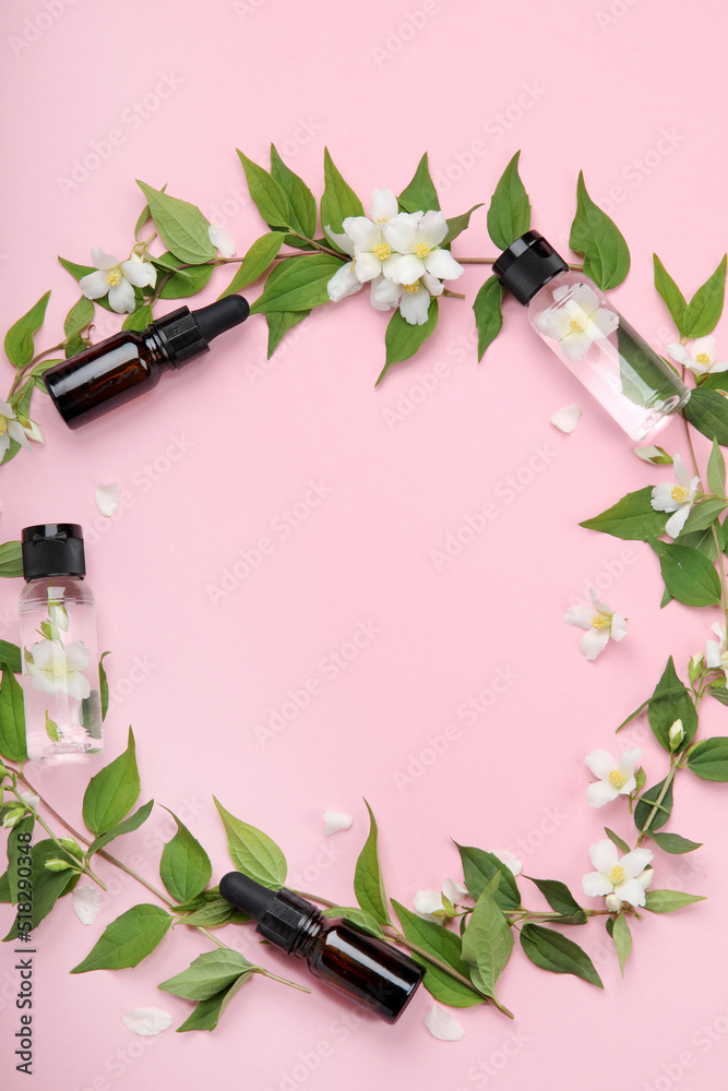 Sticker bottles of essential oil with jasmine flowers.