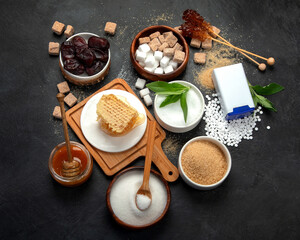 Various diet replacement for sugar on dark background.