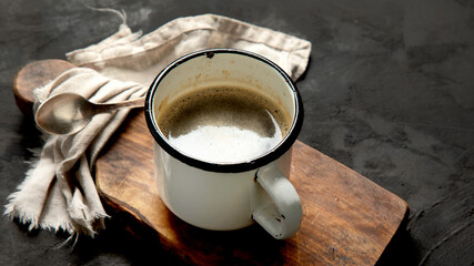 Cup of black coffee on dark background.