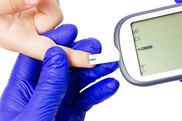 Checking blood sugar levels. Analysis of sugar with a glucometer.